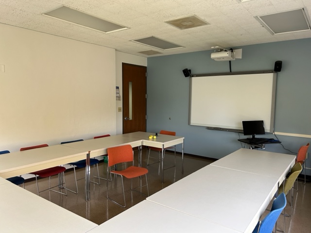 Front of the conference room with a smart board.