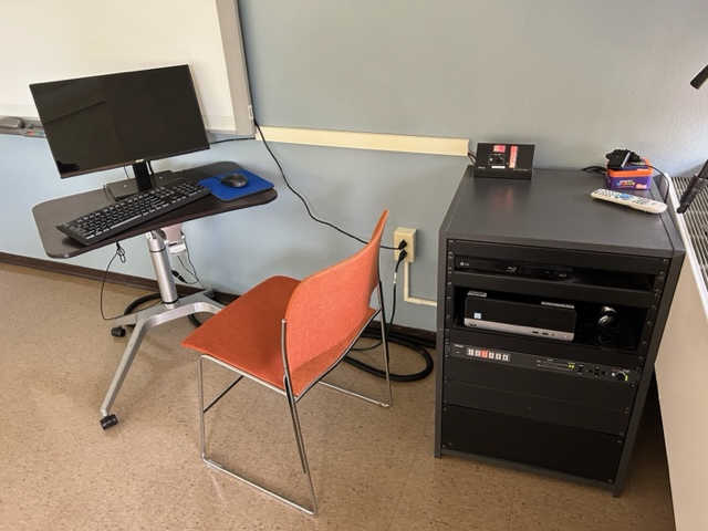 Conference Room computer station with a room control console.