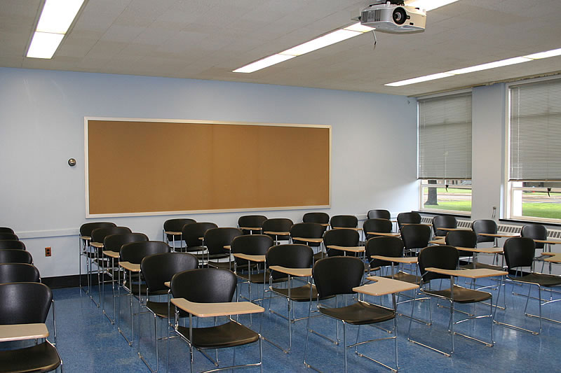 Dods 101 back of classroom with student desks and windows.