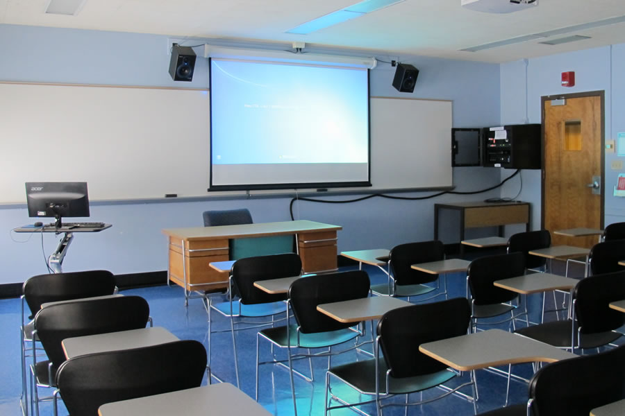 Dods 101 front of the classroom with projector and white board.