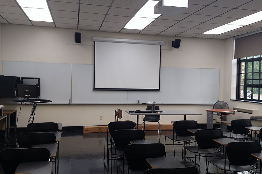 Fenton 154 front of the classroom with a large projector screen.