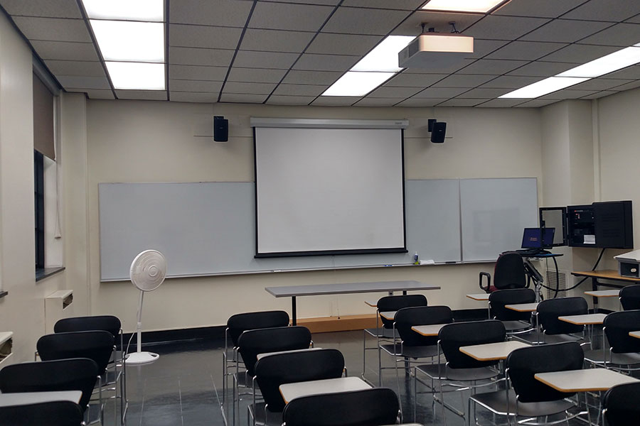 Fenton 158 front of the classroom with a large projector.