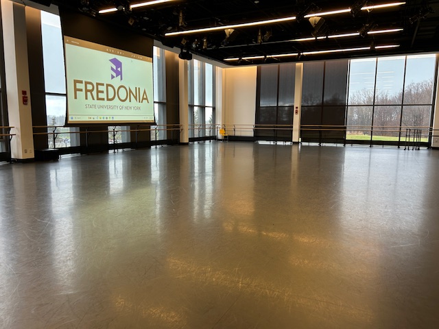 Main dancing studio with large windows on the walls.