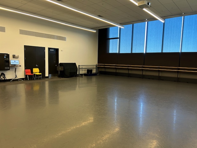 Back of the dance studio with large windows on the back wall