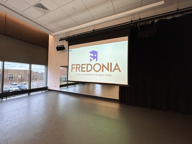 Front of the dance studio with a large projector screen.