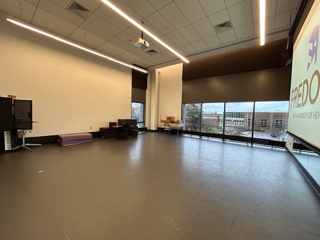 Back of the dance studio with large windows on the back wall