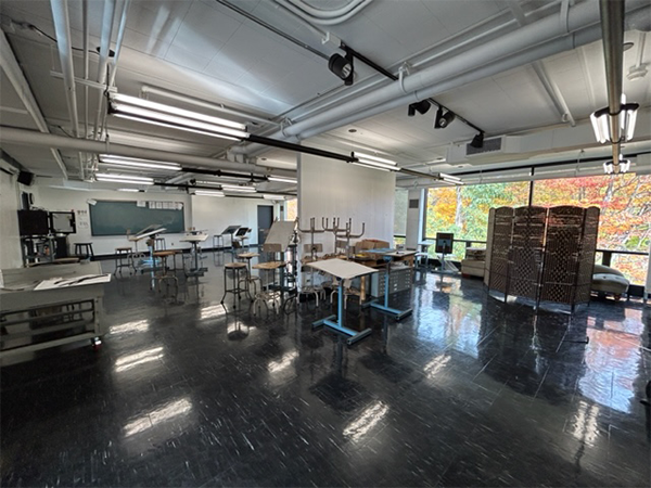 Classroom with large windows and student stations.