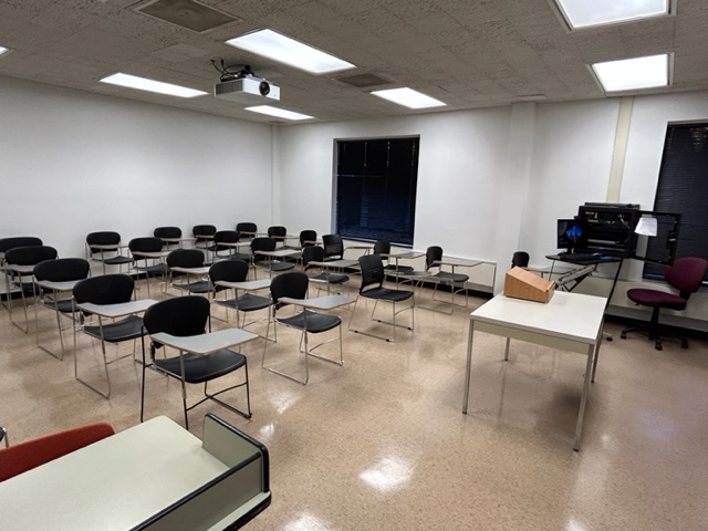 Back of the classroom with student desks in rows.