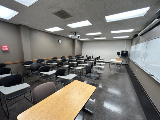 Back of the classroom with student desks arranged in rows.