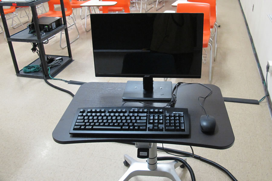 Teachers station set up with a computer monitor and keyboard.