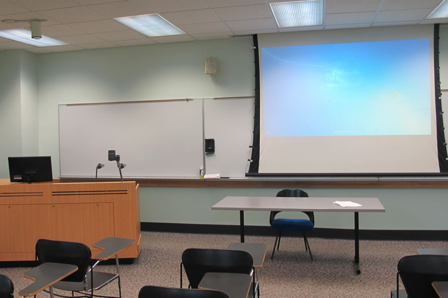 Fenton 159 front of the classroom with a large whiteboard and projector screen.