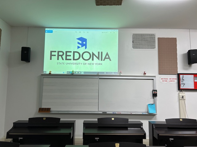 Front of the classroom with a large white board and projector