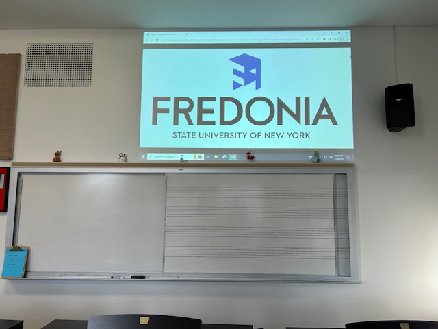 Front of the classroom with a large white board and projector 