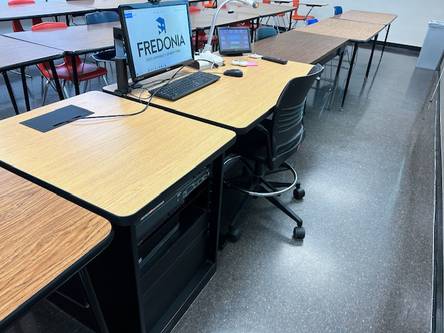 Accessible teachers desk with a computer and Extron touchpanel.