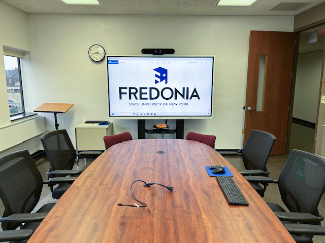 Front of the conference room with a large smart board