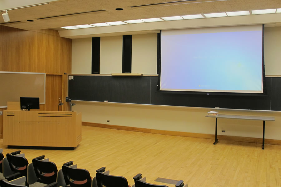 Fenton 105 front of classroom with a large projector screen.