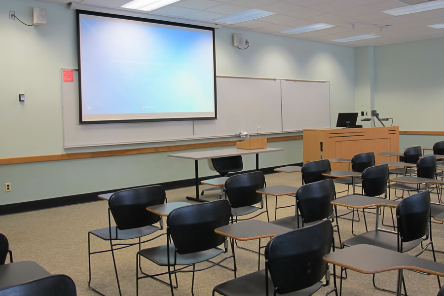 Fenton 168 front of the classroom with a large white board and projector screen.