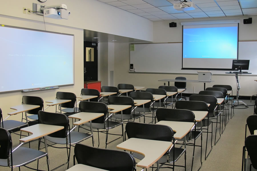 Fenton 1756 front of the classroom with a large whiteboard and projector screen.