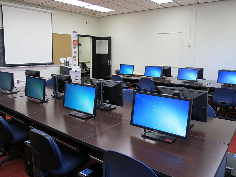 Fenton 2165 Front of the classroom with a large projector screen.