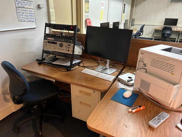Teacher's computer station with a printer.