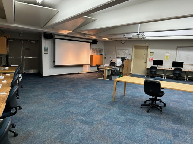 McEwen 103 Sheldon Computer Lab front view with a large projector screen.