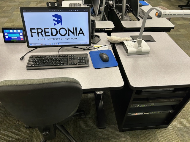 Accessible teachers computer station with an Extron Touch Panel and an Extron switcher.