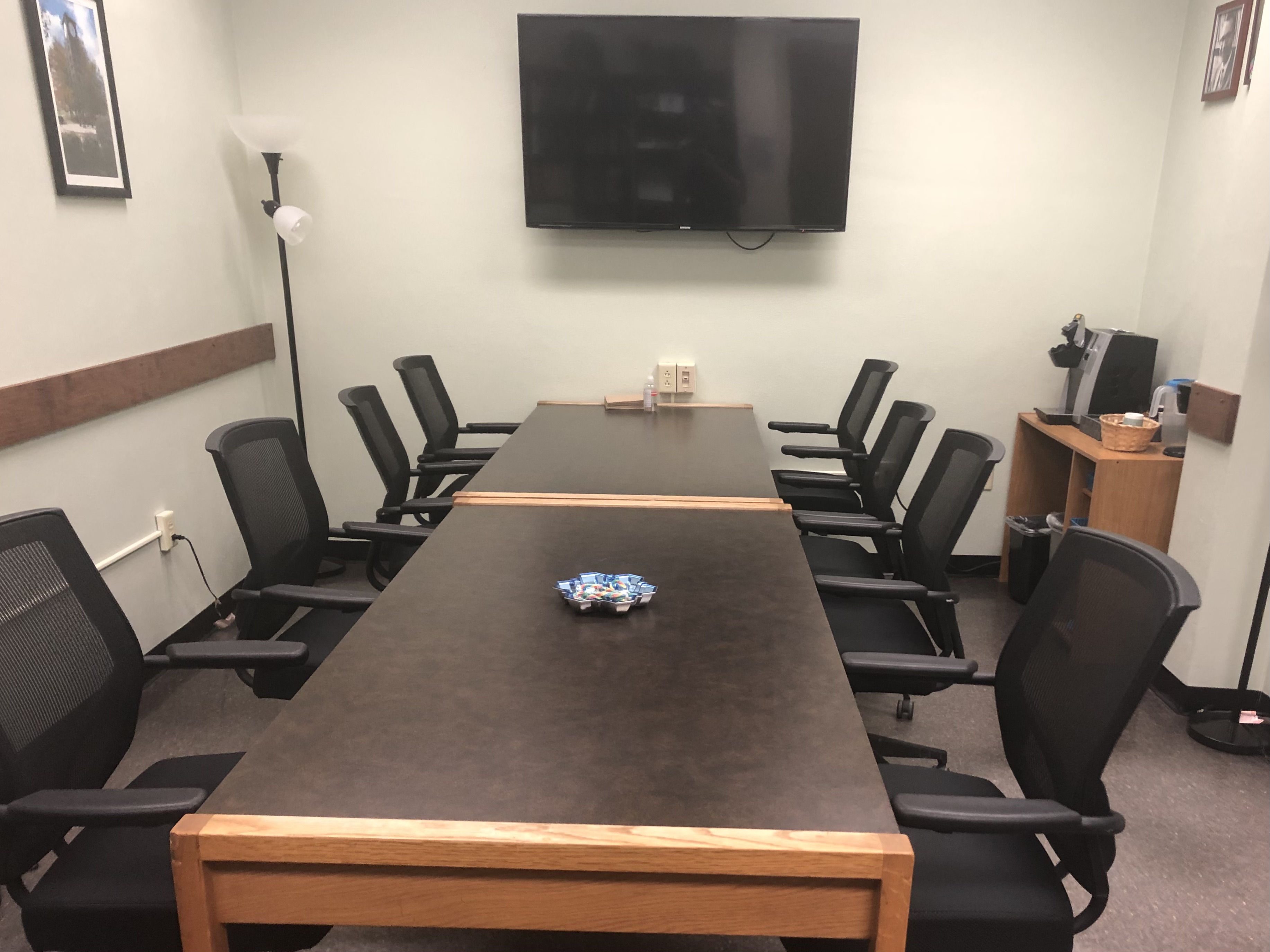 Conference Room with a table and chairs and TV.