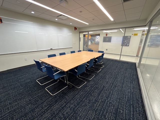 Back of the conference room with a large table and several chairs